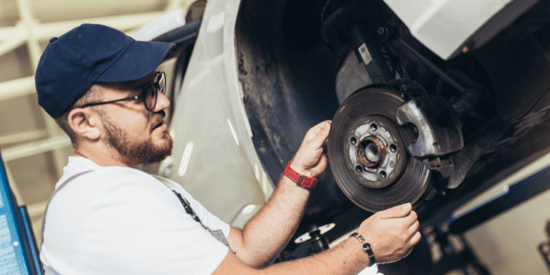repairman fixing a car wheel