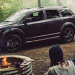 2019 Dodge Journey parked by a campfire in the forest