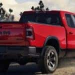 Red 2019 RAM 1500 overlooking mountains with cloudy sky