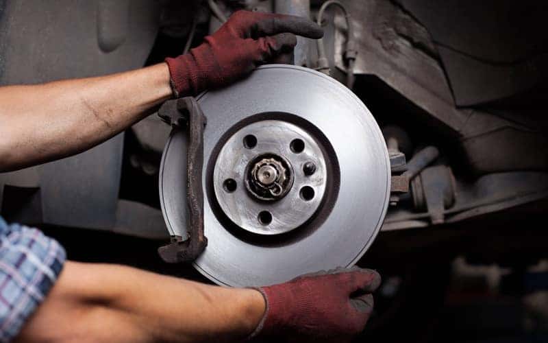 Car mechanic Repairing brakes on car
