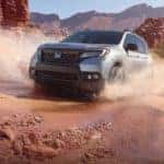 2019 honda passport in silver driving in rocky red desert