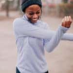 Photo of a young woman stretching out after her outdoors workout