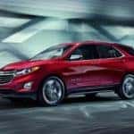 2019 Chevrolet Equinox in red driving down road