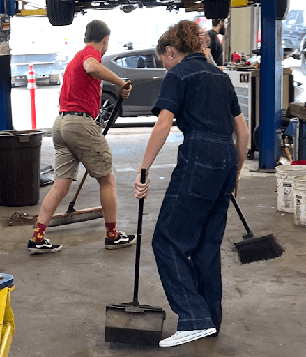 Image of two people cleaning the shop