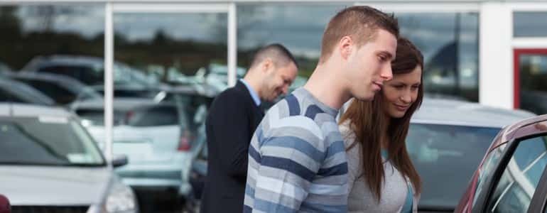 Couple looking at a new car