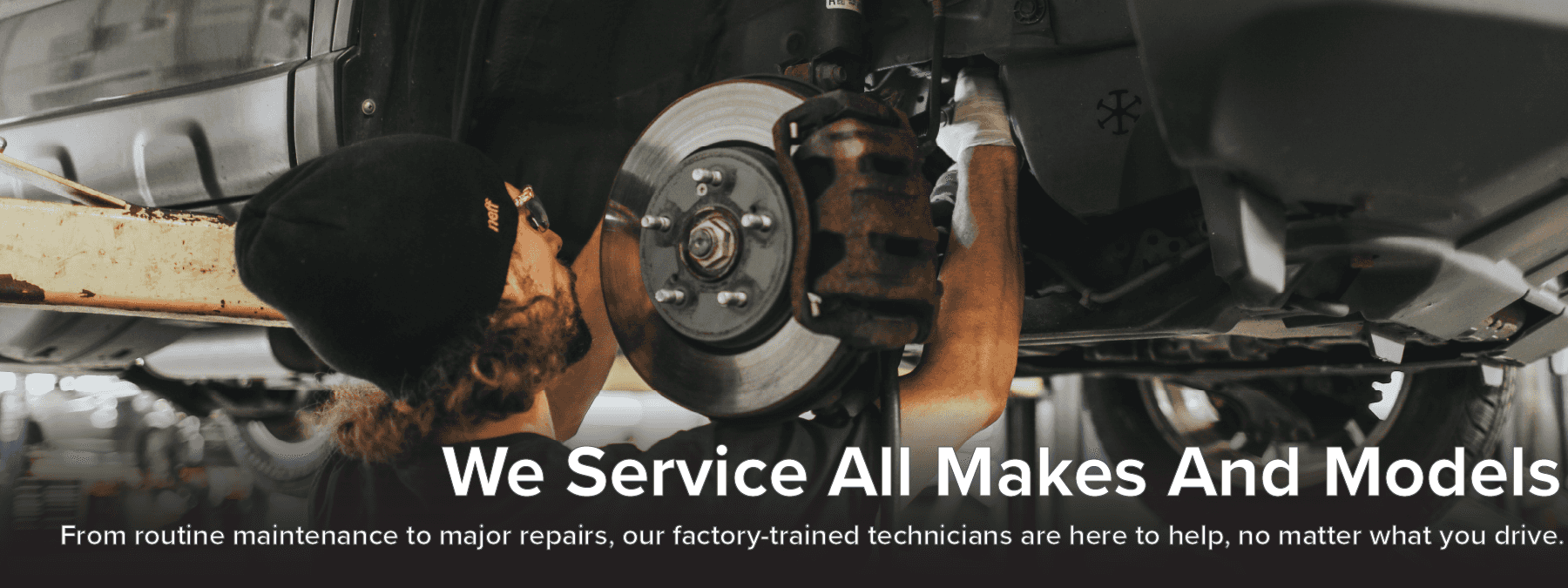 Factory-trained technician performing brake service, highlighting that service is available for all makes and models, from routine maintenance to major repairs.