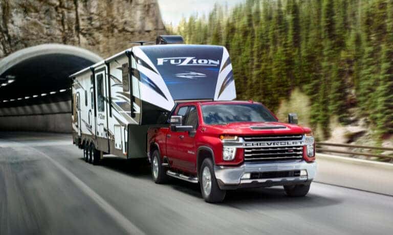 2022 Chevy Silverado 2500 HD towing camper on highway