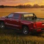 Red Chevy Silverado in Field at Sunset