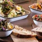 Spread of bakery items and salads