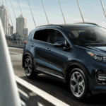 2022 Kia Sportage Driving on Bridge over City River