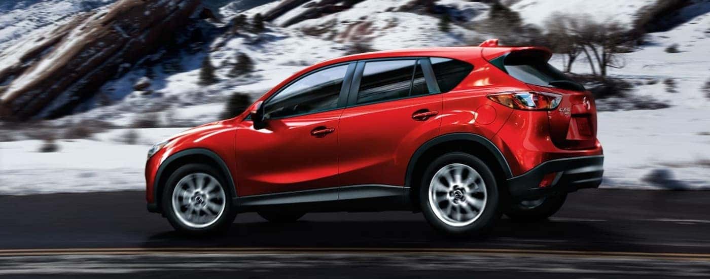 A red 2015 Mazda CX-5 is shown driving to a Mazda dealer near Hartford.
