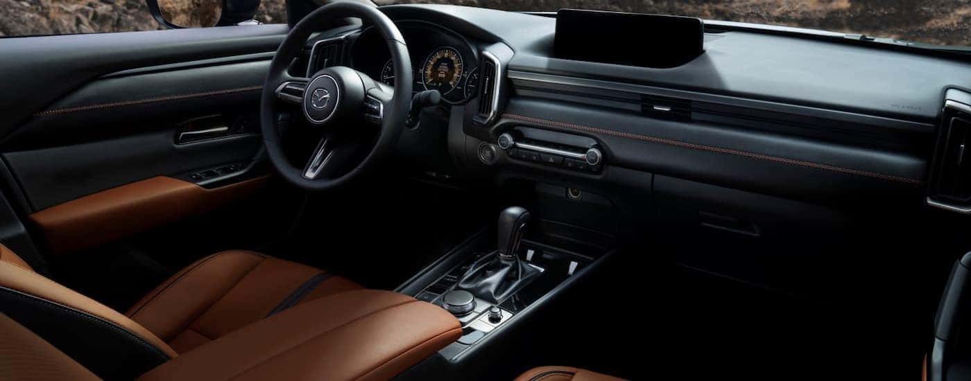 Black and tan interior of a 2025 Mazda CX-50 for sale in Manchester