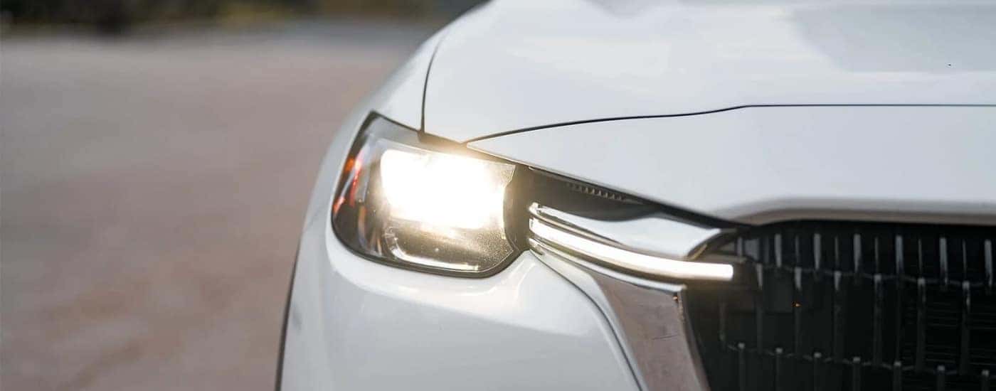 Close-up of a headlight on a 2025 Mazda CX-90 PHEV Mazda CX-90 for sale in Manchester