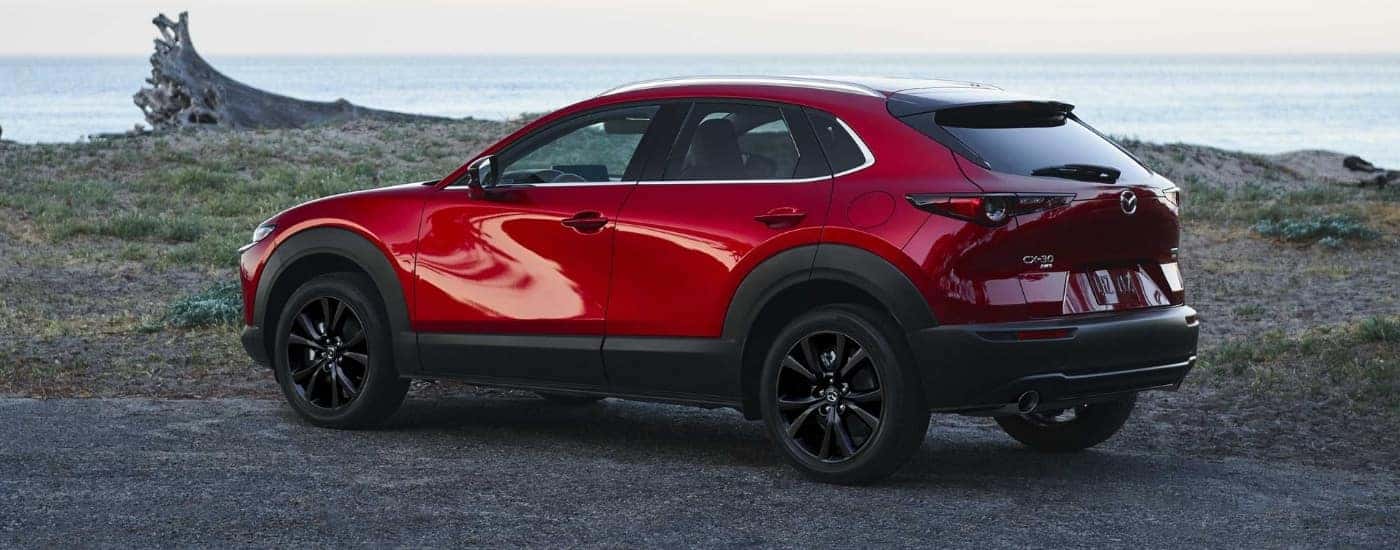 A red 2025 Mazda CX-30 for sale near East Hartford parked near a coast.