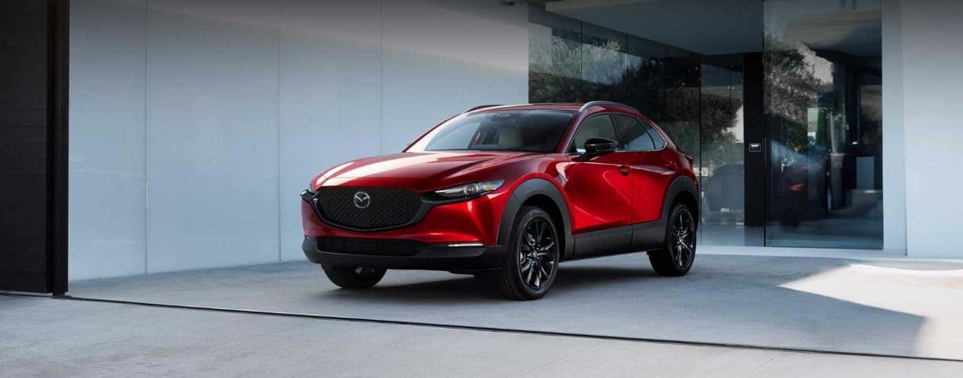 A red 2025 Mazda CX-30 for sale near Hartford parked on a driveway.