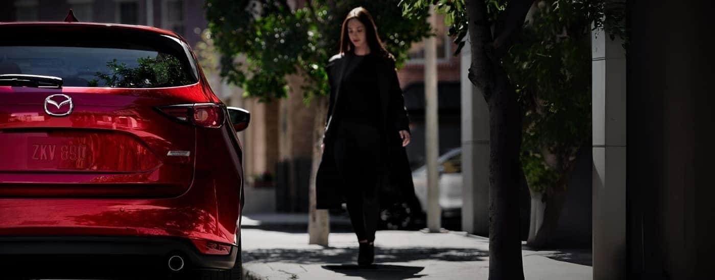 A person walking past a 2018 Mazda CX-5.