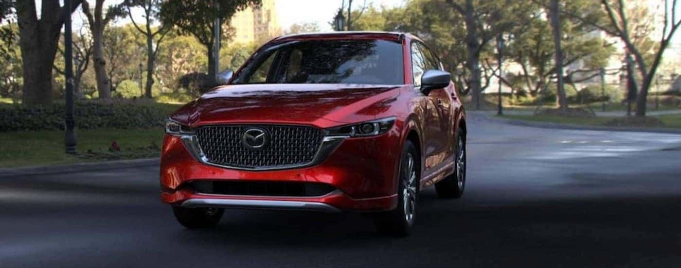A red 2025 Mazda CX-5 parked on a road.