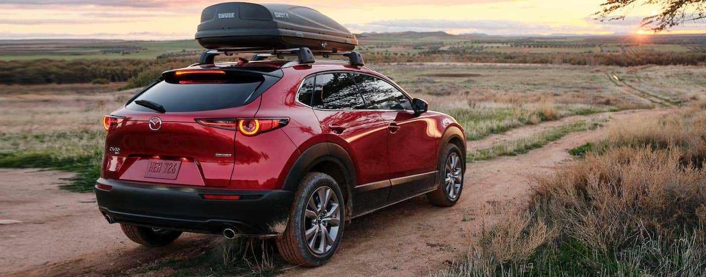 A red 2025 Mazda CX-30 for sale near Vernon from the rear at an angle.