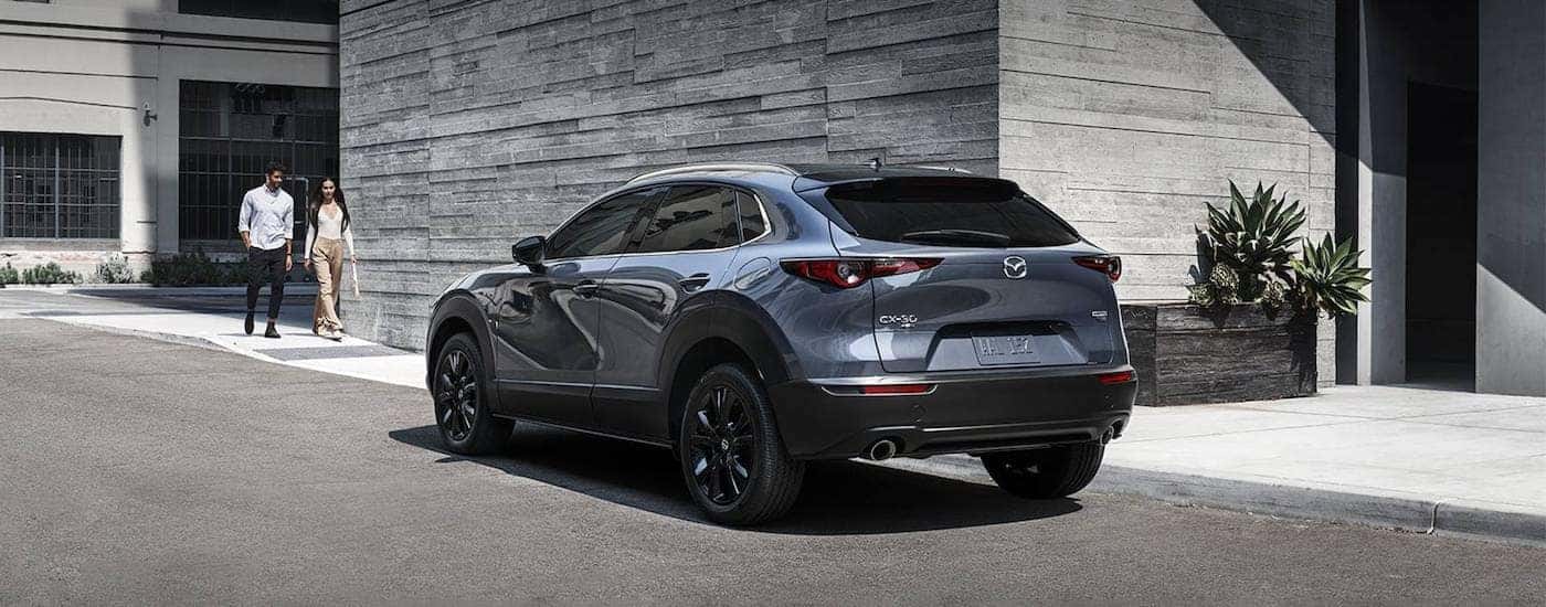 A grey 2025 Mazda CX-30 from the rear at an angle.