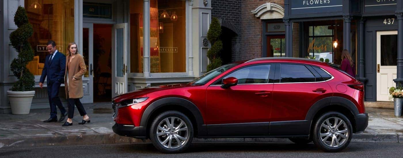 A red 2025 Mazda CX-30 parked on a city street