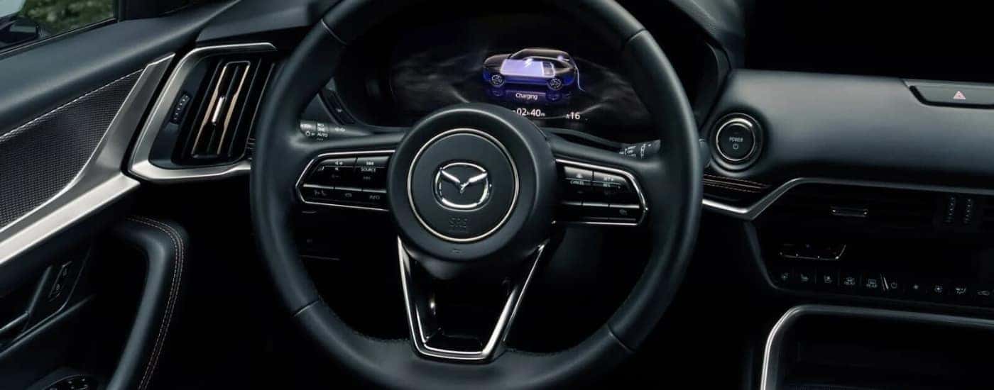 Steering wheel and dashboard of a 2025 Mazda CX-90 PHEV for sale near Hartford