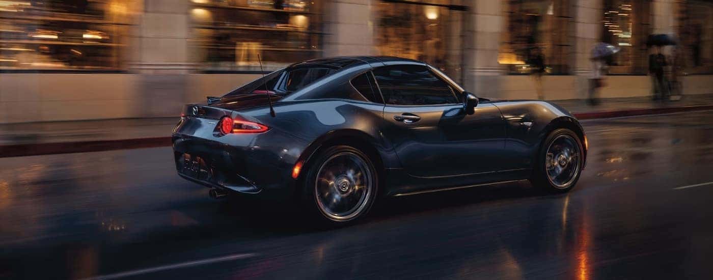 Grey 2022 used Mazda MX-5 Miata RF for sale near Vernon driving on a wet road
