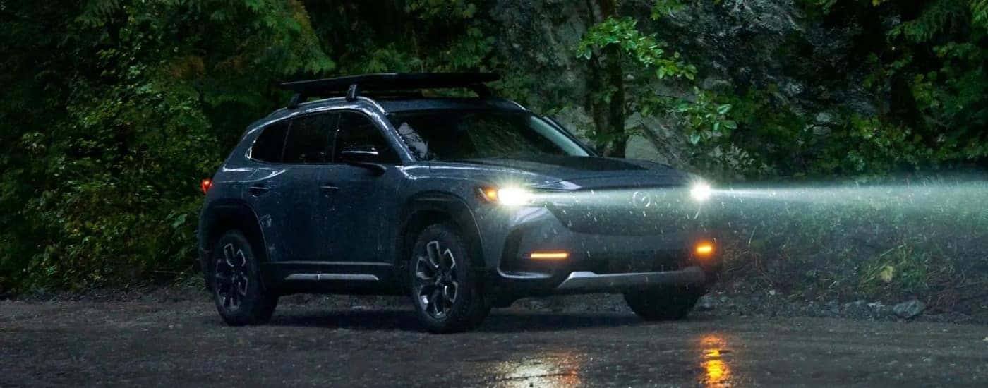 Grey 2023 Mazda CX-50 driving in the rain