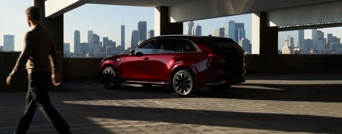 A maroon 2025 Mazda CX-90 from the rear.