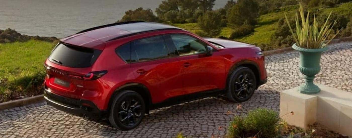 A red 2026 Mazda CX-5 parked on a driveway.