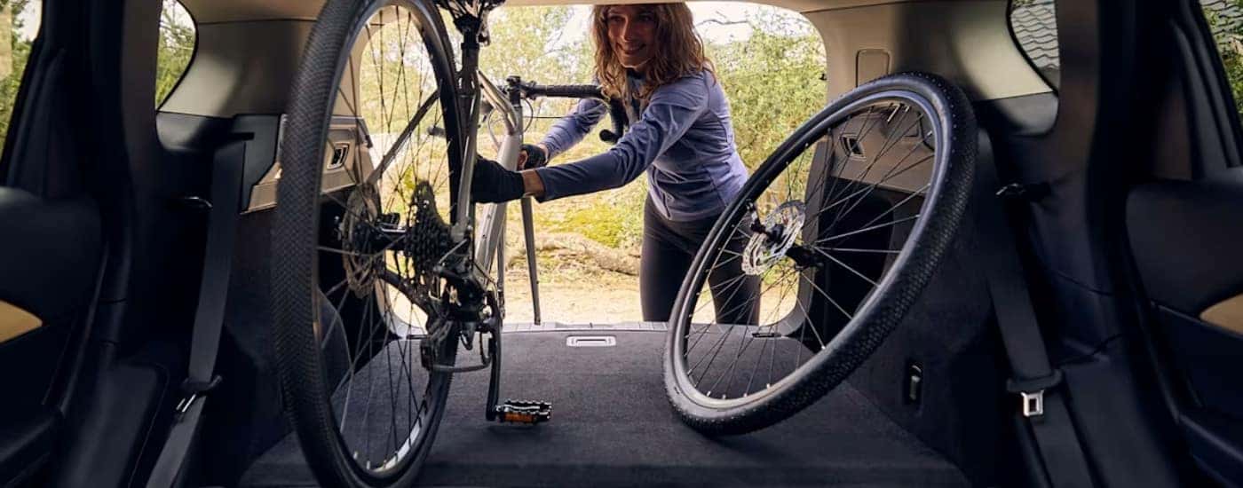 Person loading a bike in a 2026 Mazda CX-5