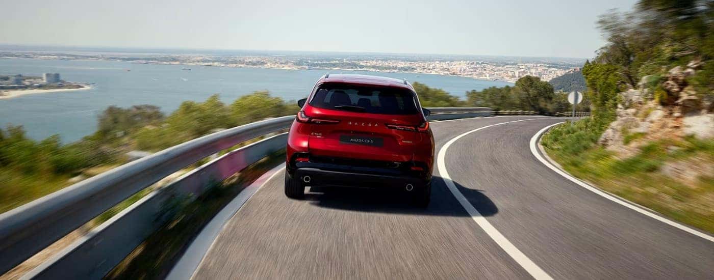 A red 2026 Mazda CX-5 for Sale in Manchester rounding a corner