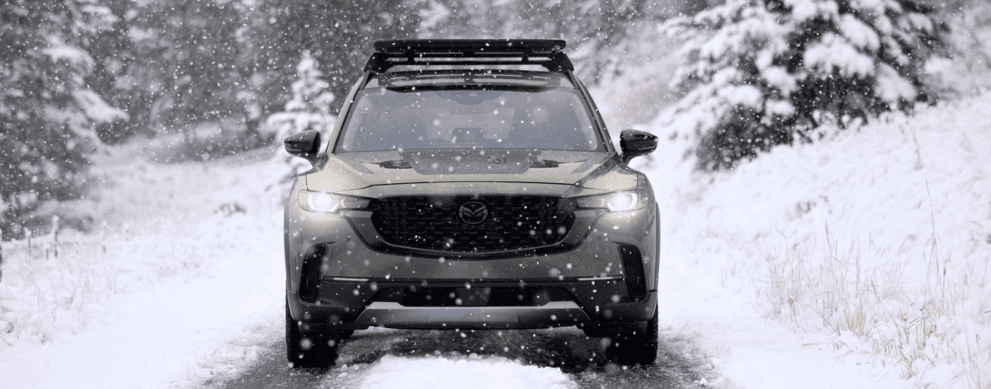 Head on of a green 2026 Mazda CX-50 in snow