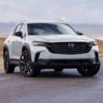 A white 2026 Mazda CX-50 parked near water.