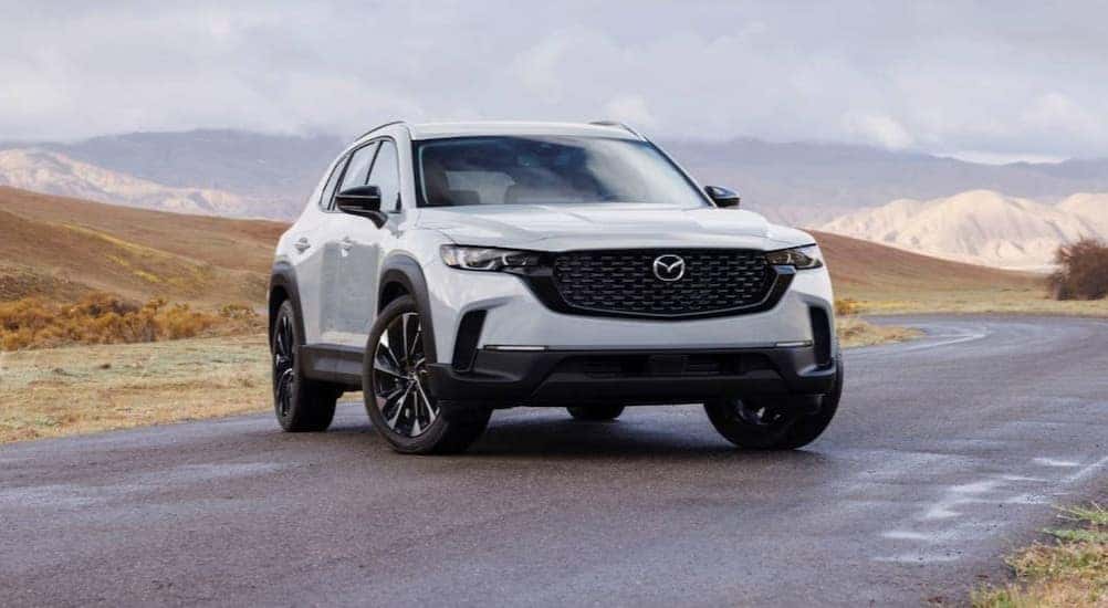 A white 2026 Mazda CX-50 parked near water.
