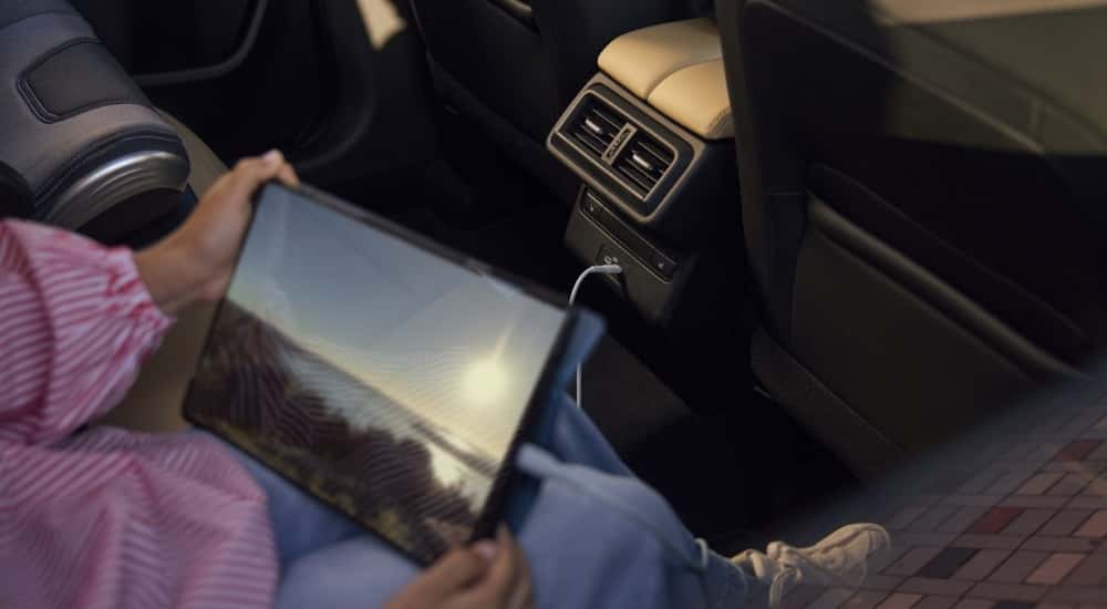 Person using a tablet in a 2026 Mazda CX-5 for sale near East Windsor