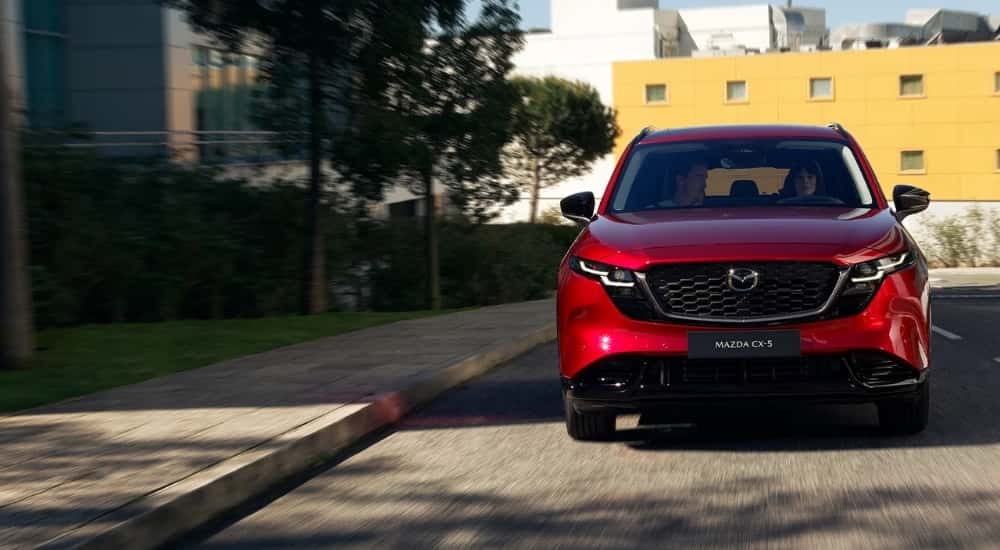 Red 2026 Mazda CX-5 for sale driving on a city street