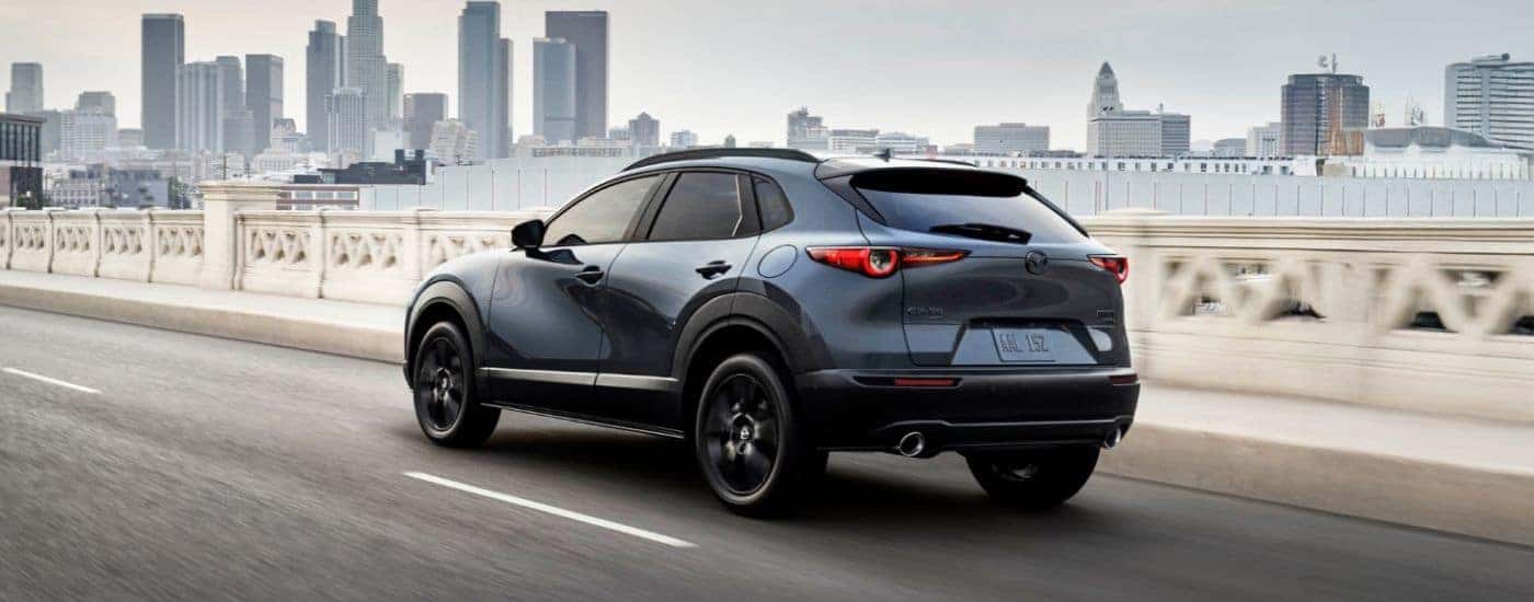 Blue 2026 Mazda CZ-30 driving into the city