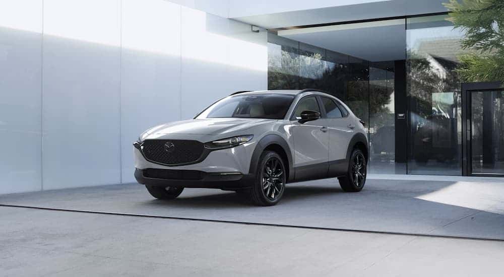 A gray 2026 Mazda CX-30 parked outside a building