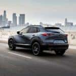 A dark blue 2026 Mazda CX-30 driving in a city