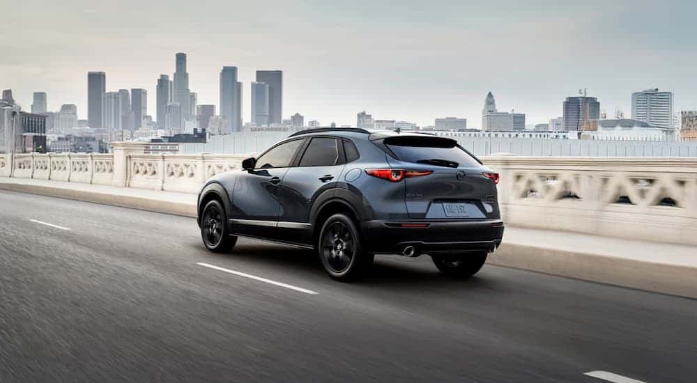 A dark blue 2026 Mazda CX-30 driving in a city