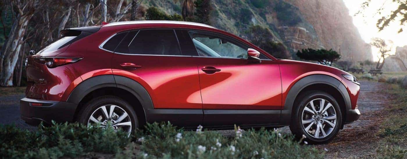 Red 2026 Mazda CX-30 parked off-road in the mountains.