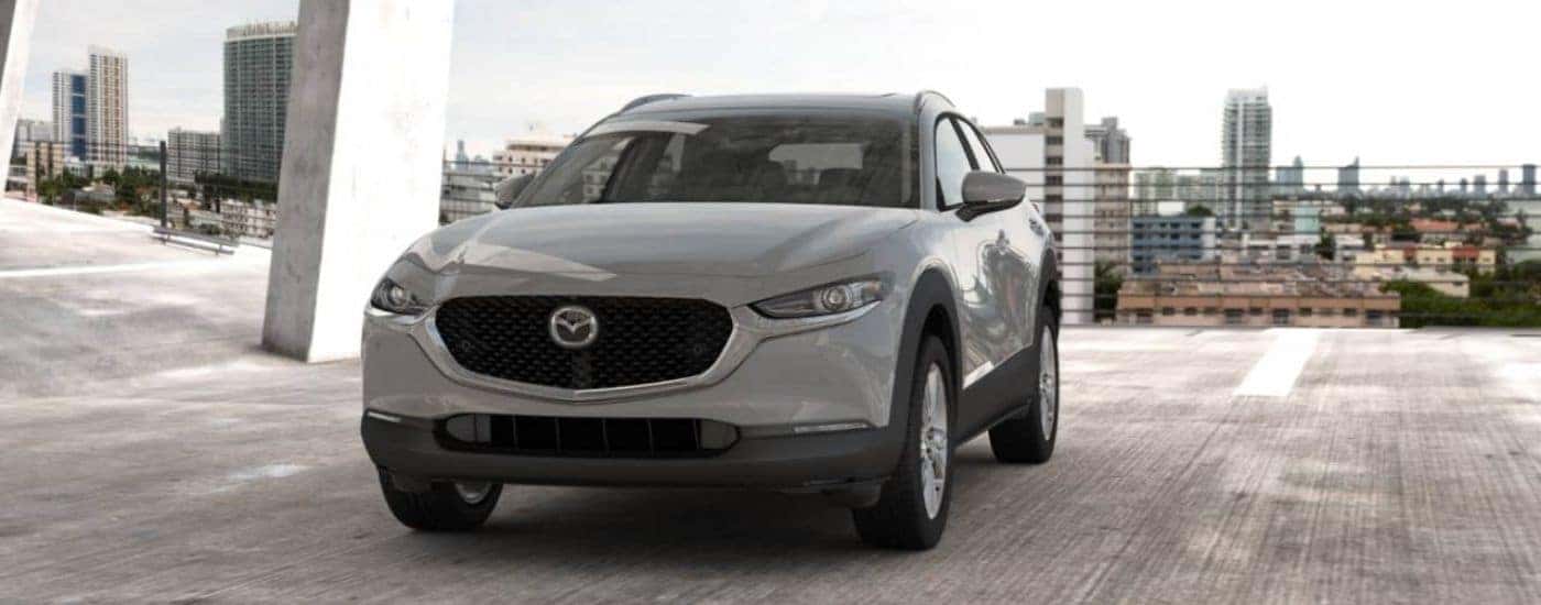 Silver 2026 Mazda CX-30 parked in a garage above the city.