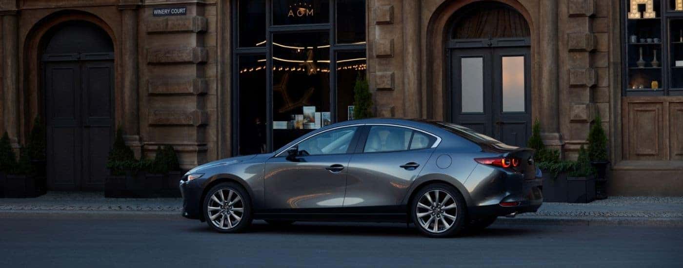 A gray 2026 Mazda3 parked outside of a winery.