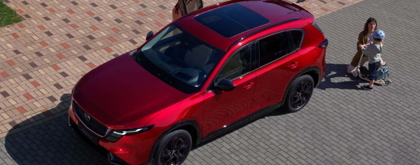 Aerial view of a red 2026 Mazda CX-5 with a mom and her child.