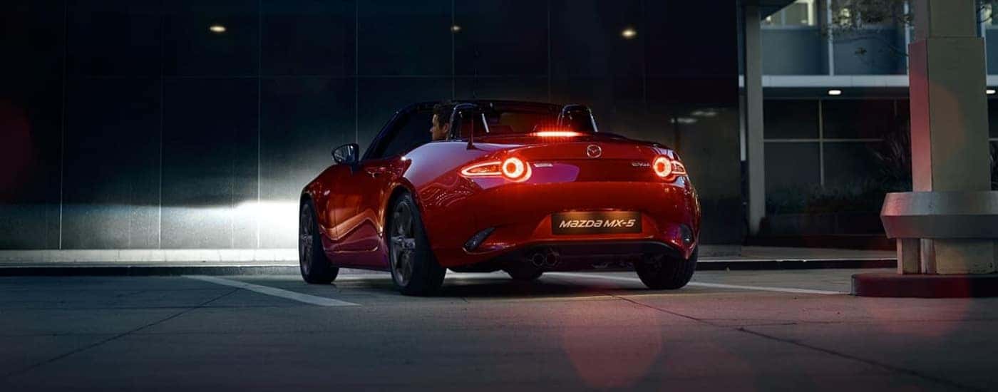 Red 2023 Mazda MX-5 Miata parked near a building