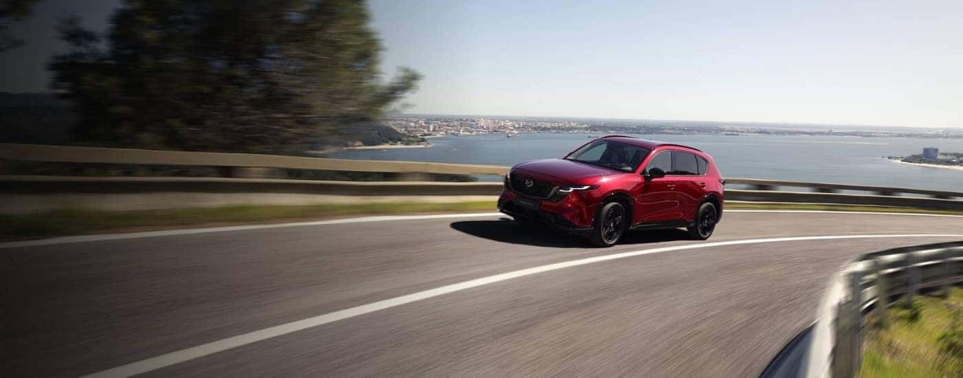Red 2026 Mazda CX-5 driving on a highway