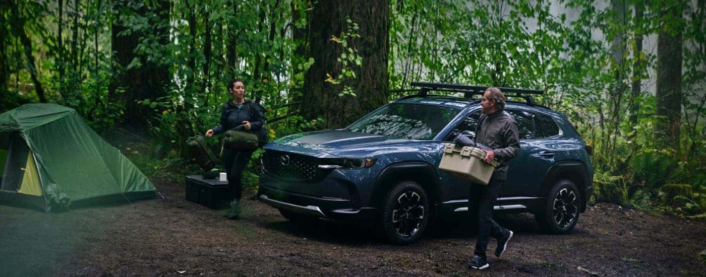 Blue 2026 Mazda CX-50 at a campsite