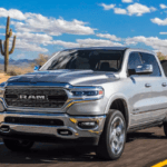 Silver Ram 1500 towing boat on highway