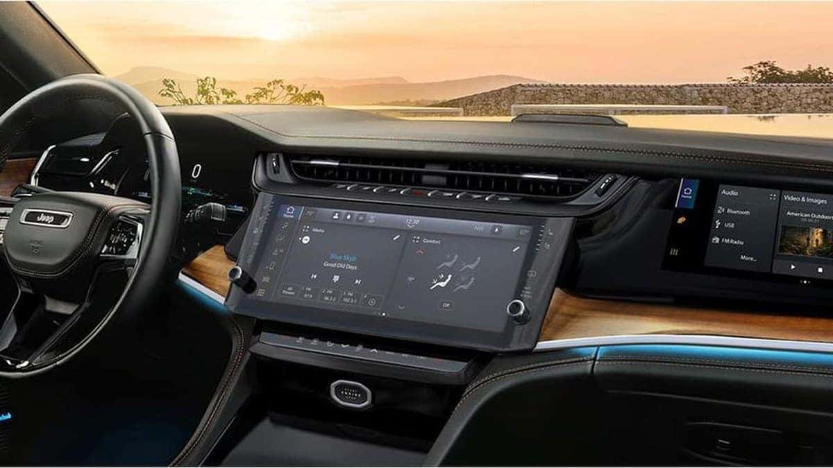 2026 Jeep Grand Cherokee Summit dashboard with Uconnect 5 touchscreen and front passenger screen