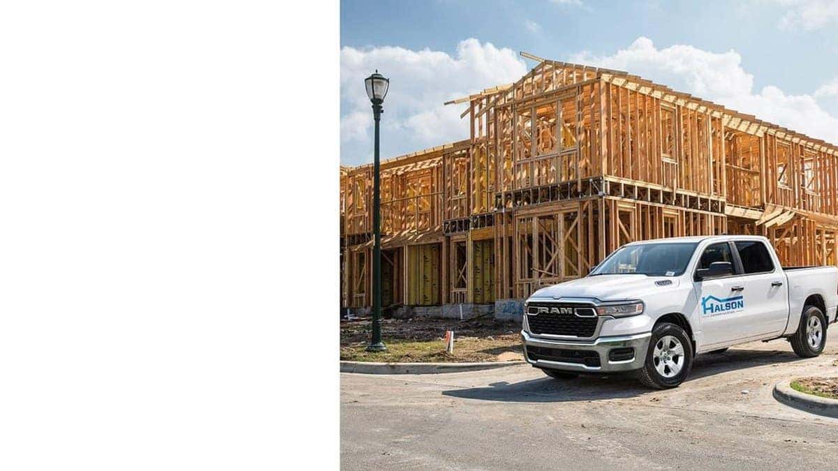 White 2026 Ram 1500 work truck parked at a residential construction site
